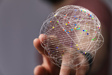 Close-up of a hand holding a digital globe representing global connectivity and data exchange, innovation, and communication.