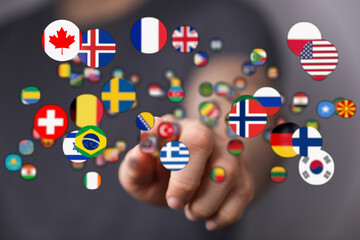 Person's finger pointing towards floating flags of different countries, symbolizing global...