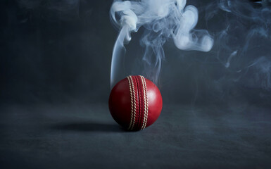 Dramatic Red Cricket Ball on Dark Background with Smoke