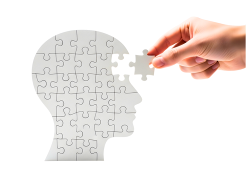 Hand placing last puzzle piece into head silhouette isolated on transparent background