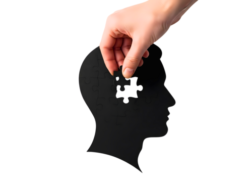 Hand placing last puzzle piece into head silhouette isolated on transparent background