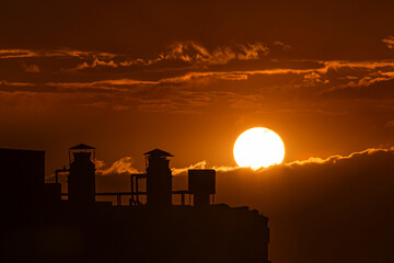 Sunset in the city with beautiful warm tones over the clouds
