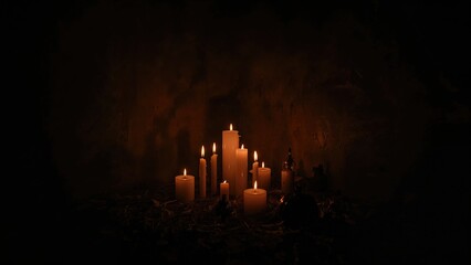 Candle lights in a dark room with dim illumination and warm glow. Soft lighting and ambiance. The mood of tranquility and serenity.