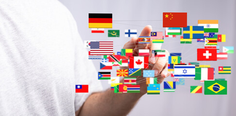 Person interacting with a digital network of world flags, representing global connections and international relations.