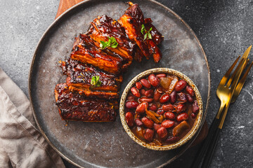 Sliced grilled meat steak Rib eye medium rare set, in a plate, with beans, on grey background top view