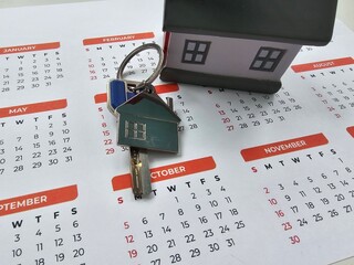 Finding your new home with keys and a calendar to mark important moving dates concept