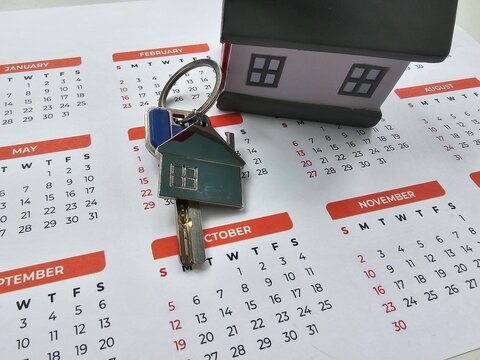 Finding your new home with keys and a calendar to mark important moving dates concept