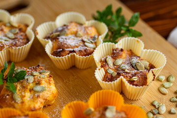 Homemade cottage cheese muffins with pumpkin seeds on board