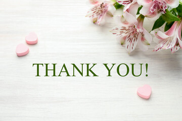 Phrase Thank you, flowers and decorative hearts on white wooden table