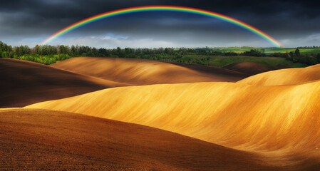 Rainbow Over Plowed Rolling Hills 