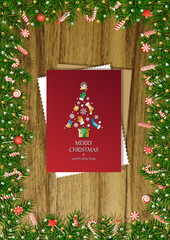 A wooden vertical surface decorated with Christmas decorations, a holiday card lies on the table, creating a warm festive atmosphere