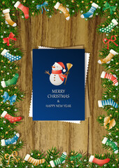 A wooden vertical surface decorated with Christmas decorations, a holiday card lies on the table, creating a warm festive atmosphere