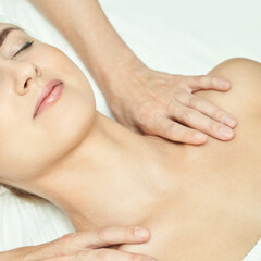 Caucasian female receiving relaxing massage therapy for stress relief and wellness.