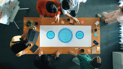 A diverse team collaborates around a conference table, analyzing graphics and notes in a modern office, enhancing creativity and strategic planning through discussion. Trope