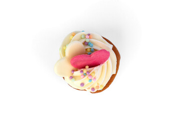 Delicious cupcake with white cream and sprinkles isolated on white background.