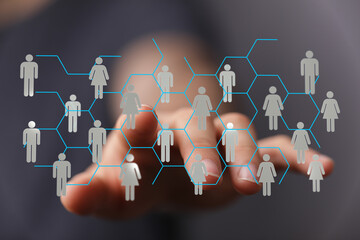 Visual of a person's hand interacting with a network of people icons, representing social...