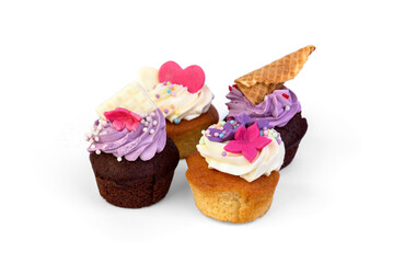 Delicious cupcakes with cream and sprinkles isolated on white background.