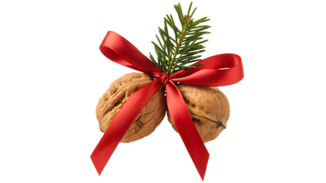 Two walnuts tied with a red ribbon and evergreen sprig isolated on transparent background