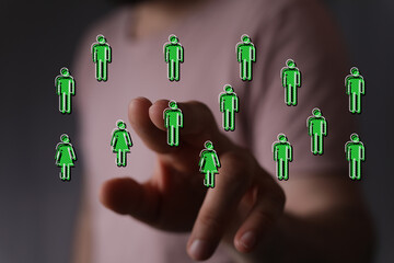 Digitally rendered illustration showing a person's hand touching a network of connected human...