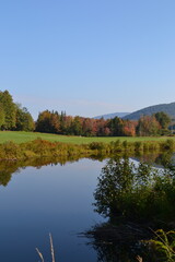 pond with colorful autumn trees surrounding