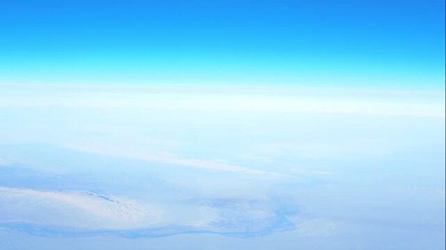 Captivating view from above of stunning mountain peaks standing tall against clear blue sky, offering  inviting glimpse into breathtaking mountainous scenery, motion background