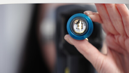 Close-up of an ophthalmic instrument held by a healthcare professional, showcasing precision optics and advanced technology for vision examination and eye care procedures