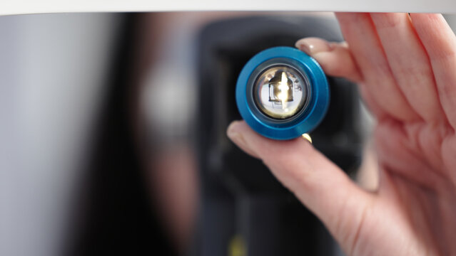 Close-up of an ophthalmic instrument held by a healthcare professional, showcasing precision optics and advanced technology for vision examination and eye care procedures