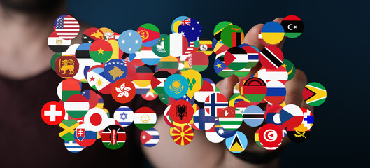Hand holding flags of countries around the world. Concept of global unity, international cooperation, and worldwide connections.