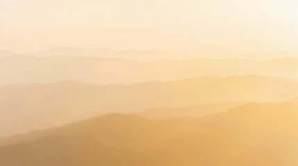 Hazy mountain ridges fade into the golden light of dawn, creating an ethereal landscape