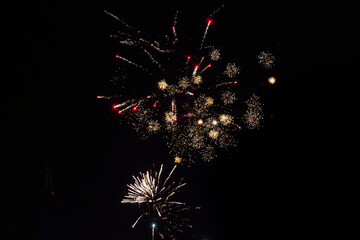 Shot of a large yellow firework in the night sky of Vienna