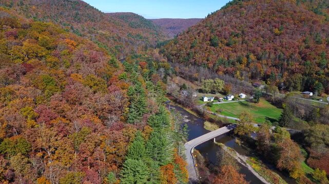 Mountains in Autumn Fall colors with peaceful creek winding through countryside in morning light in Pennsylvania, Pine Creek near Pennsylvania Grand Canyon at Blackwell, PA