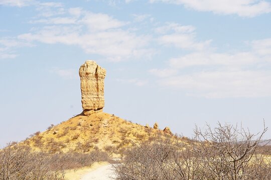 Scenic shot of the Vingerklip, a rock formation in Damaraland in northern Namibia, not far from the Ugab Terraces during the dry season. The sandstone rock needle is ancient and 35 metres high. 