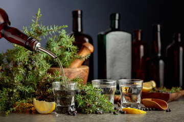 Gin is poured from a vintage bottle into a glass.
