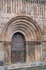 Fototapeta premium Royal monastery of Santa María de Veruela, 12th century Cistercian abbey, Romanesque façade around a splayed semicircular door, door of the abbey church , Vera de Moncayo, Zaragoza province, Spain