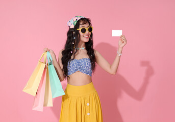 Asian woman holding shopping bags and showing blank credit card with smile representing summer fashion online payment retail discount promotion and joyful consumer lifestyle