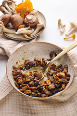 Finely chopped chanterelle, oyster and champignon mushrooms fried with carrots and onions