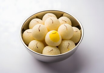 Top view of delicious rasgulla in a bowl, a popular indian and bengali sweet dish with saffron
