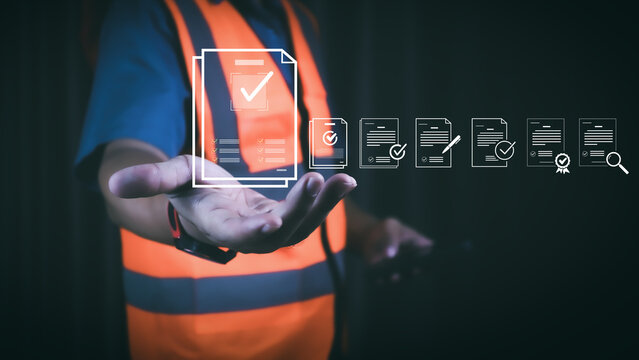 Engineer using digital checklist and document verification hologram for smart inspection, quality control, and industrial safety management in modern manufacturing and construction technology.