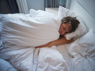 Lonely 35 year old woman sleeping alone after breakup, sadness and emotional emptiness 