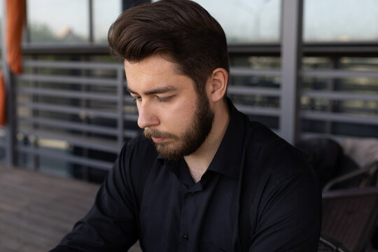 The man is looking down in cafe - Powered by Adobe