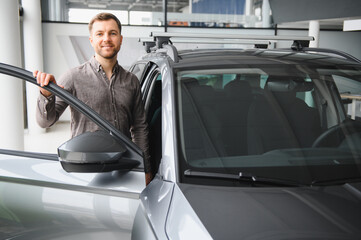 Man exploring options in modern car showroom