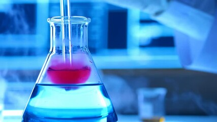 Laboratory reaction in a flask — blue liquid and pink indicator, science and chemistry - Powered by Adobe