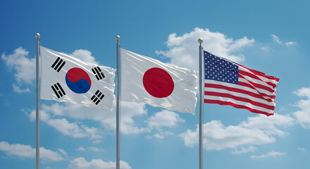 Flags of south korea japan and the united states waving against a blue sky with white clouds visible