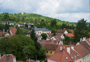 Red-roof village houses surrounded by lush green hills