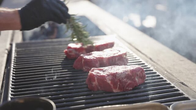 Steak being grilled on fire outdoors