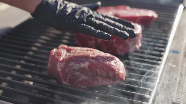 Steak being grilled on fire outdoors