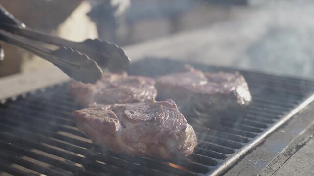 Steak being grilled on fire outdoors