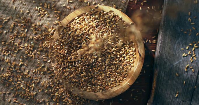 Slow Motion Close Up of Spelt grains falling and scattering across rustic wooden table, sunlight and natural textures creating an organic cinematic pattern at 1000 fps