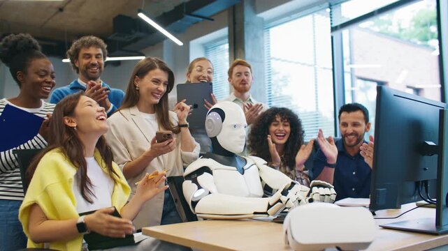 Humanoid robot completing data entry on computer keyboard while research team cheering and celebrating experiment success. Engineers excited about breakthrough in artificial intelligence performance.