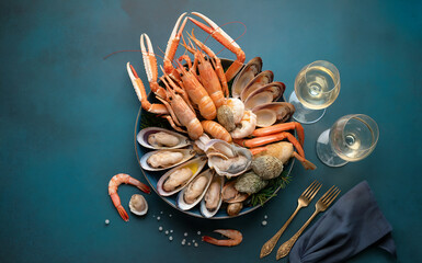 French cuisine (Christmas). A variety of seafood (le plateau de fruit de mer) – langoustines, crab claws, shrimp, shellfish, etc.

Top view